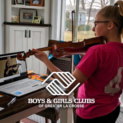 Teenage girl, who is a member of the Boys & Girls Clubs of Greater La Crosse, is playing her violin over Zoom with her instructor.