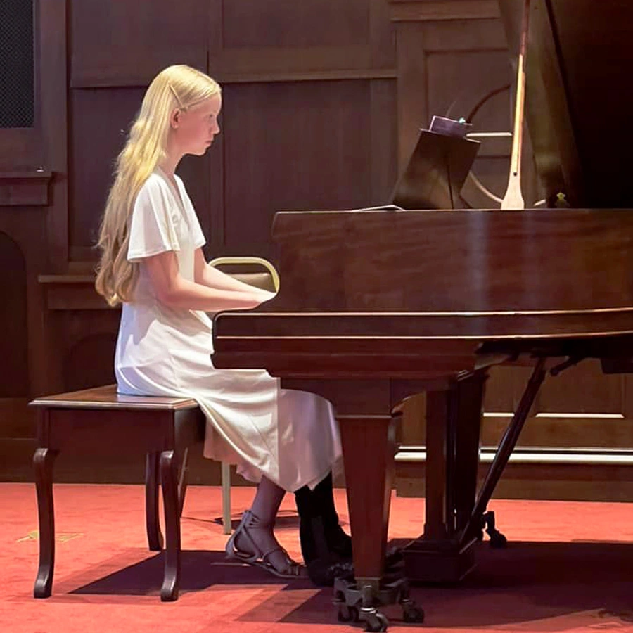 Female pianist performing at Cappella Performing Arts Center during the piano chamber recital in La Crosse, Wisconsin.