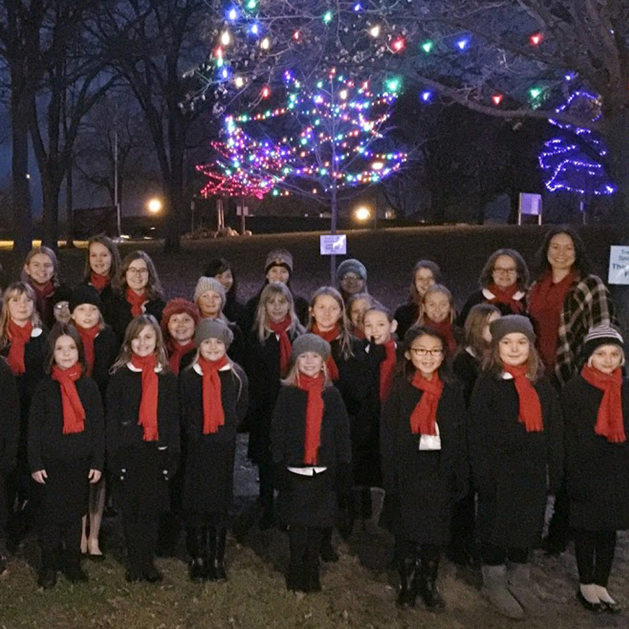 La Crosse Girlchoir posing in front of the Rotary Lights after a performance in La Crosse, Wisconsin.