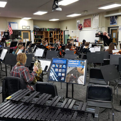 La Crosse Youth Symphony Orchestra rehearsing in a school orchestra room.